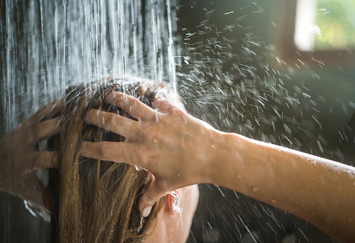 Close Up Of A Woman Washing Her Hair While Showering In The Morning.